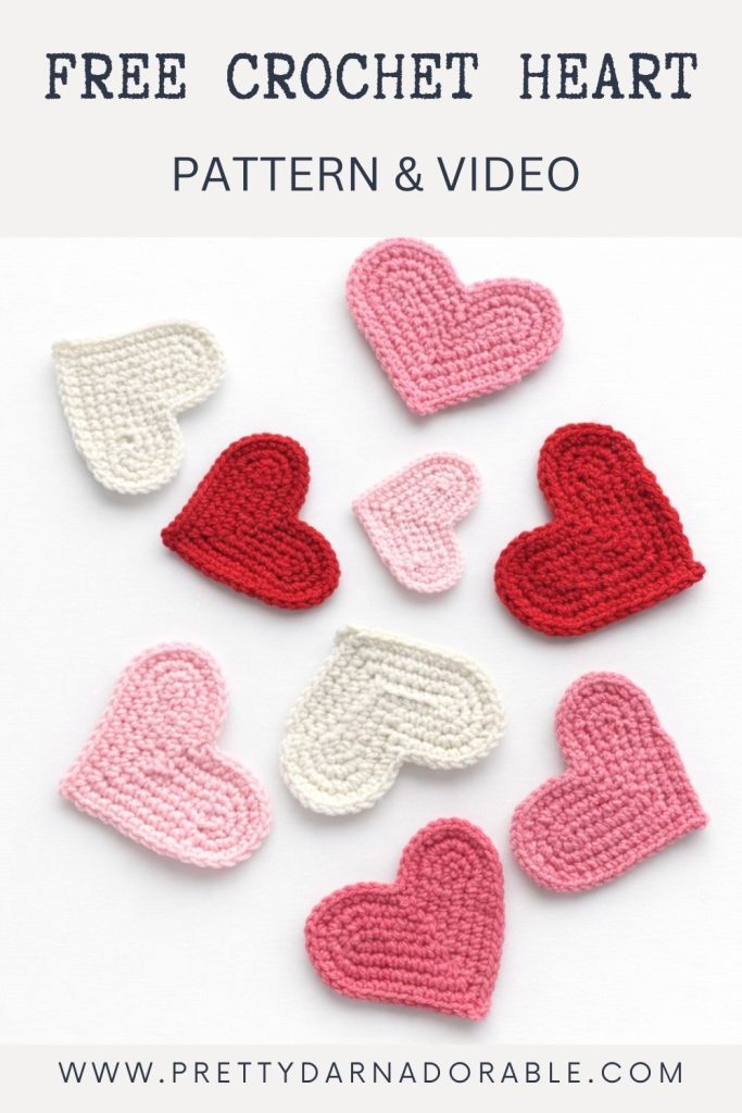 Red, pink, and white crocheted hearts on a white background with text: “HOW TO CROCHET A HEART – Free Pattern & Video.” Website www.prettydarnadorable.com at bottom. Free crochet pattern