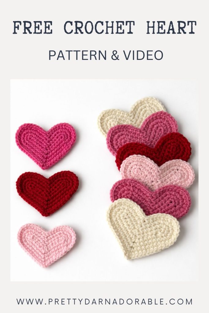 Pink, red, and cream crocheted hearts on a white background; text above offers a free crochet heart pattern and video. Website link below. Free crochet pattern