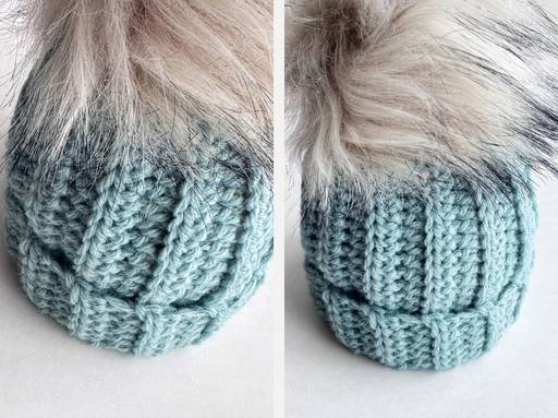 Close-up of a light blue hat with wide ribbed texture and a large fluffy faux fur pom-pom on white, shown from two angles. Free crochet pattern