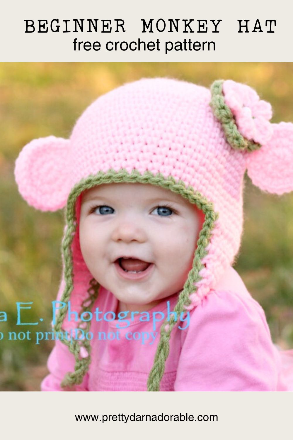 A smiling baby wears an easy, worsted weight beanie—a pink crochet hat with ear flaps, green trim, a flower, and round ears like a monkey. Text above reads “Beginner Monkey Hat free crochet pattern.” Website at the bottom.