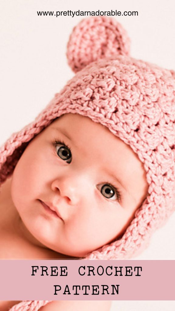 baby wearing a crochet bear hat with ear flaps