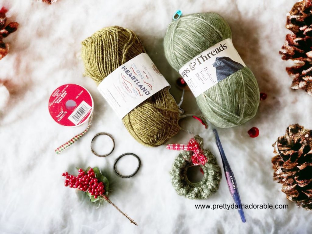 two skeins of green yarn ribbon and mini crochet wreath