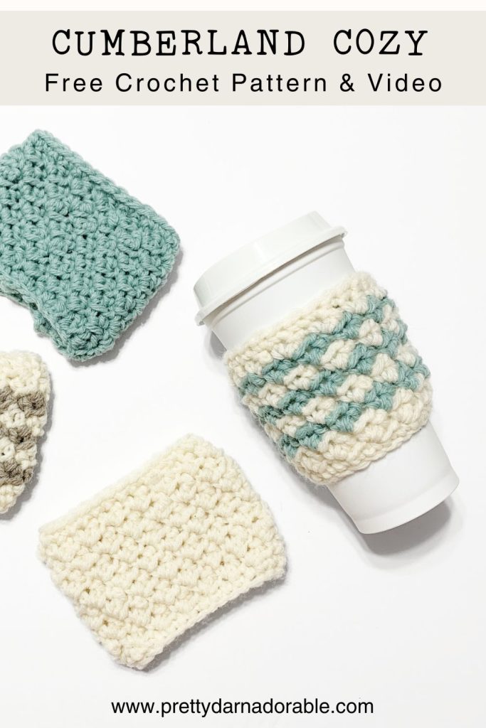 a coffee cup with a crocheted coffee cozy on it