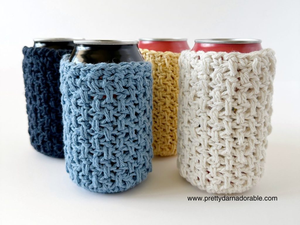 three crochet can cozies in pastel colours