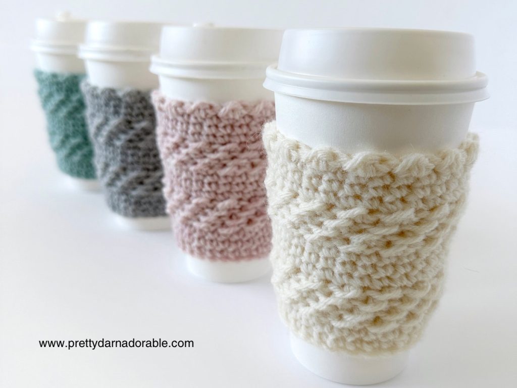 four standing cups with crochet cup cozies