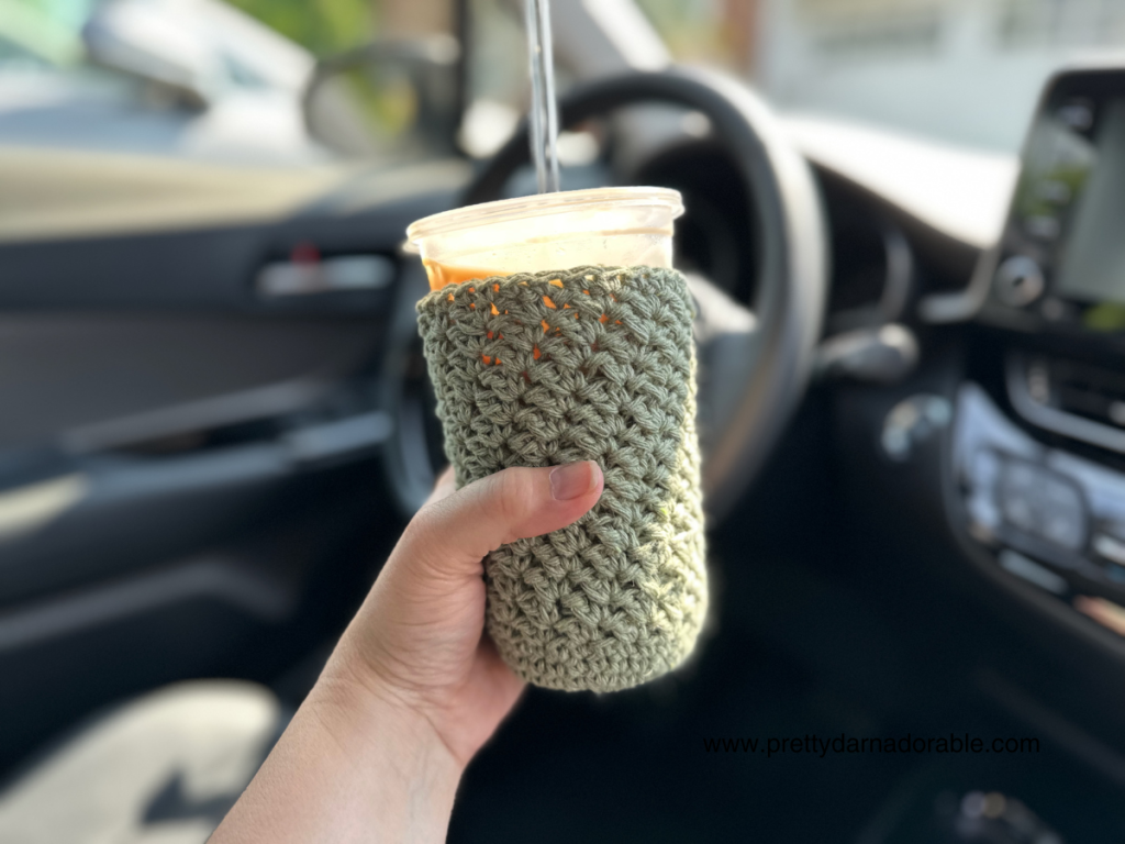 Textured crochet cup cozy with bottom in a car
