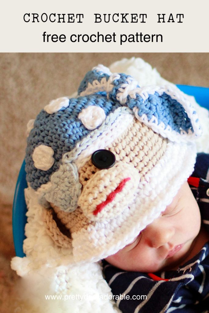 crochet bucket hat that looks like a pirate sock monkey made from red white and blue the monkey has an eye patch too. Free crochet bucket hat pattern.