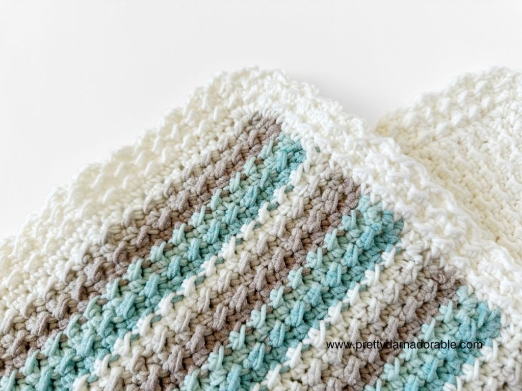 close up of striped crochet dishcloth with contrast border made of the crochet crunch stitch