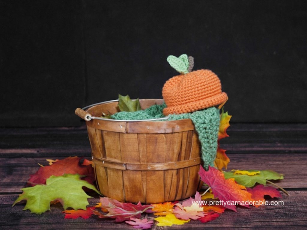 crochet pumpkin hat sitting on a basket. Free crochet pumpkin hat pattern and video