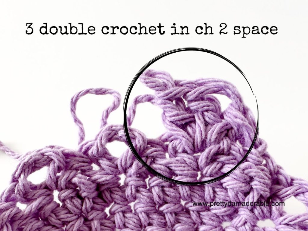 Close-up of lavender crochet stitches with a circular outline highlighting the 3 double crochet in ch 2 space technique, featuring instructional text at the top&mdash;perfect for mastering techniques in a free crochet bucket hat pattern.