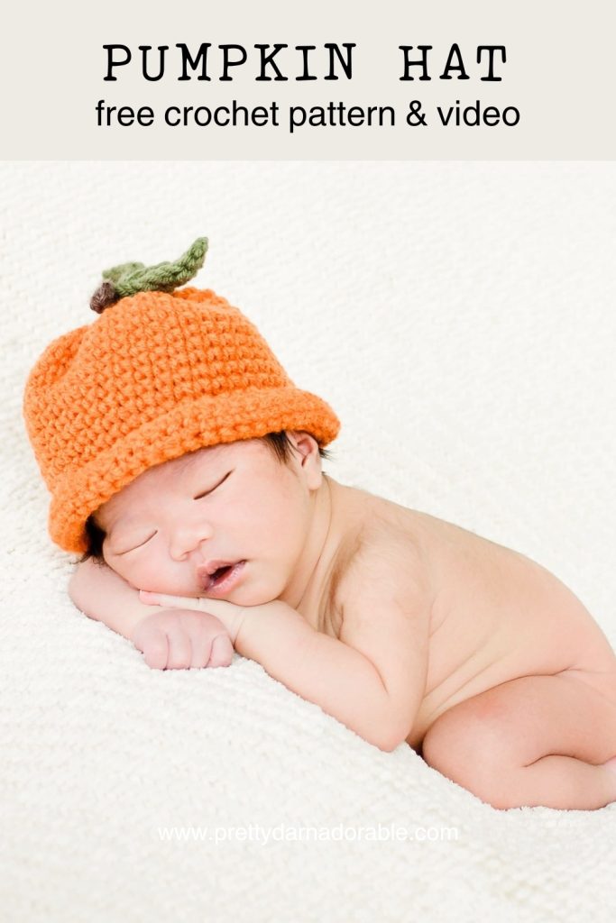 baby wearing orange crochet pumpkin hat with leaves. Free crochet pumpkin hat pattern and video