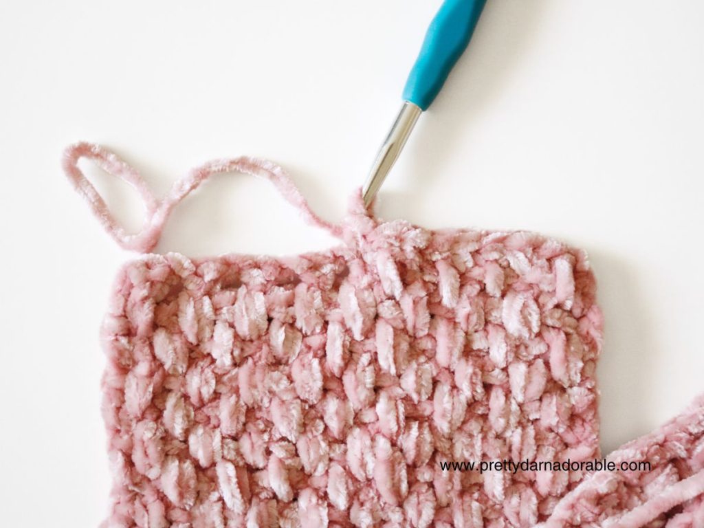 a close up of a pink crocheted headband ends