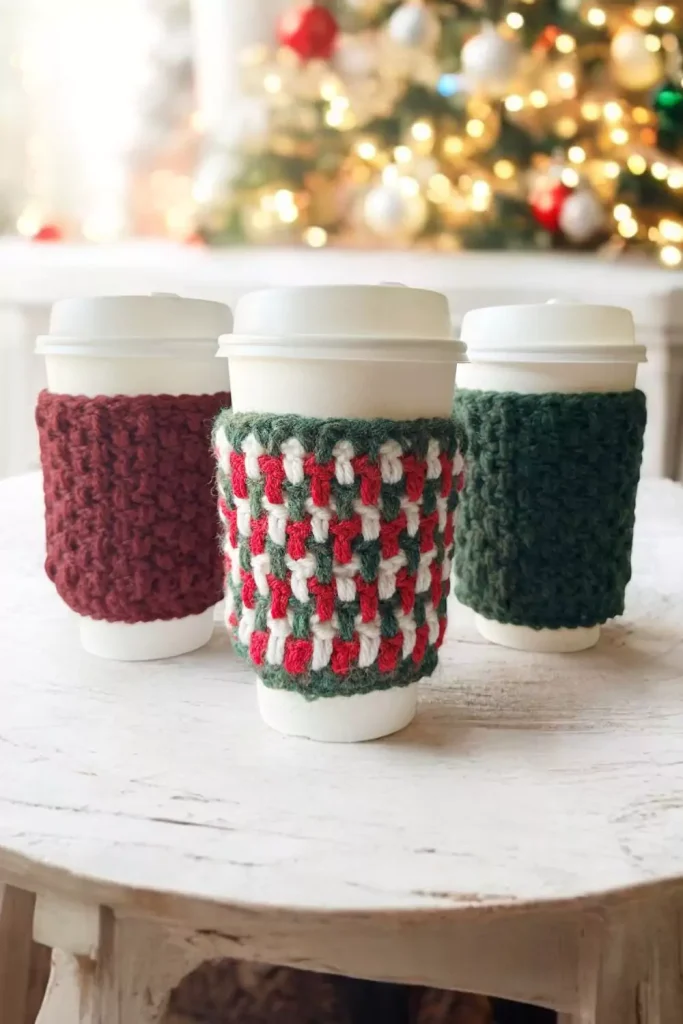 3 crochet coffee cozies in christmas colours