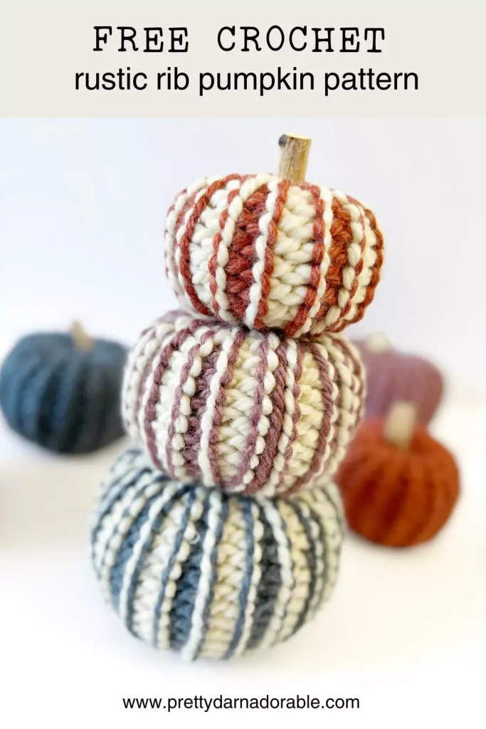 stack of crochet pumpkins in orange pink blue and cream