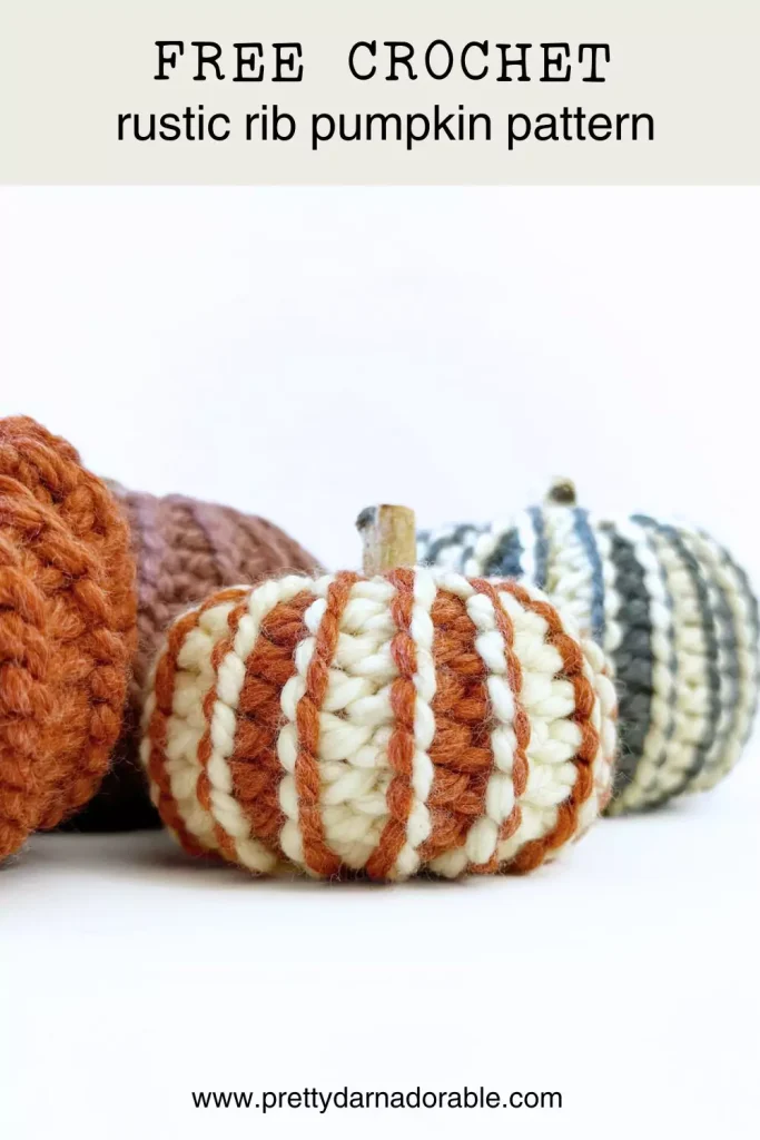 bunch of crochet pumpkins in orange pink blue and cream