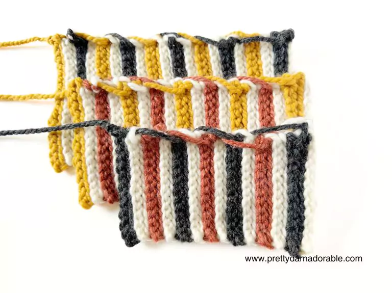 Five small crocheted swatches with vertical stripes in yellow, white, pink, and dark gray are fanned out on a white background. Free crochet pattern