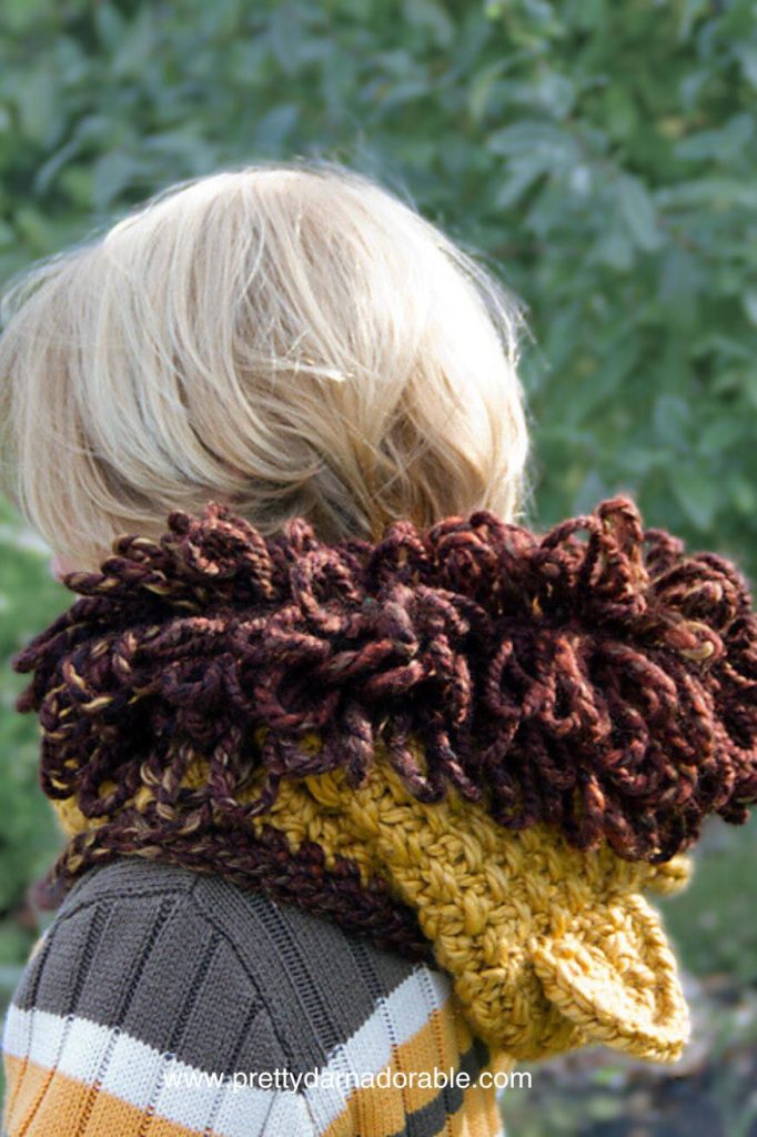 child wearing lion crochet hooded cowl
