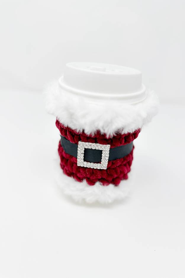 red crochet cup cozy with fur trim rhinestone buckle and black belt - looks like santa