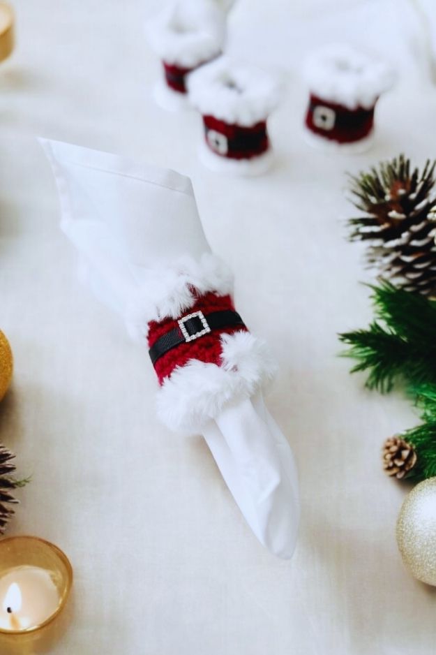 red napkin ring with white fur trim with black belt and rhinestone buckle