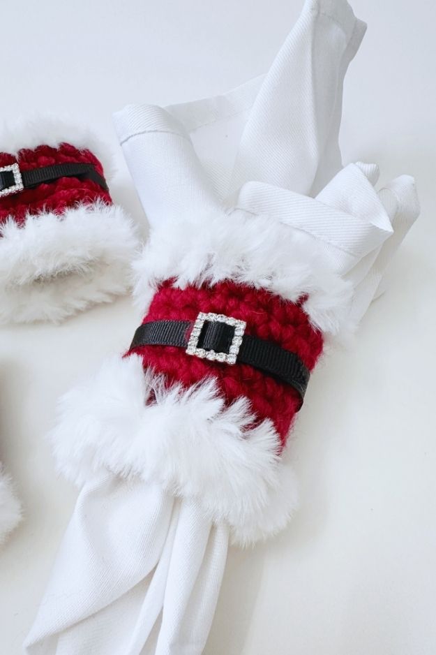 red napkin ring with white fur trim with black belt and rhinestone buckle