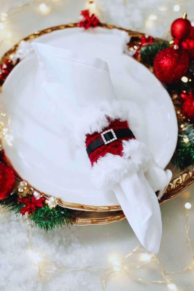 red napkin ring with white fur trim with black belt and rhinestone buckle