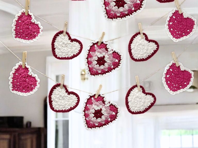 pink striped granny stitch hearts with picot trim hanging on a garland