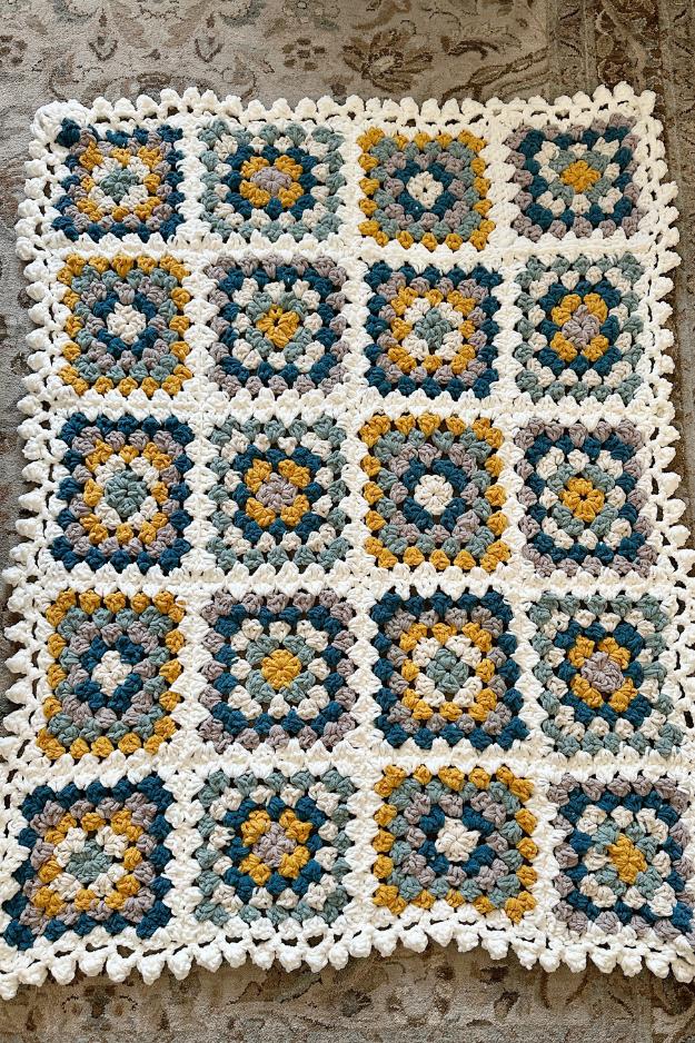 close up of a chunky chenille crochet granny square with a bobble edge
