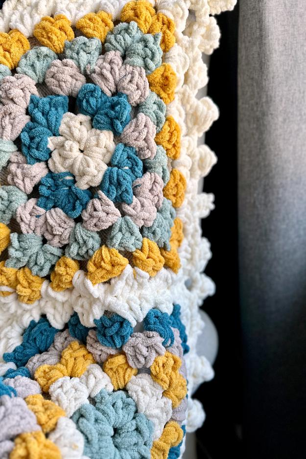 close up of a chunky chenille crochet granny square with a bobble edge