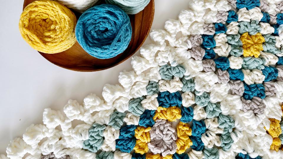 close up of a chunky chenille crochet granny square with a bobble edge