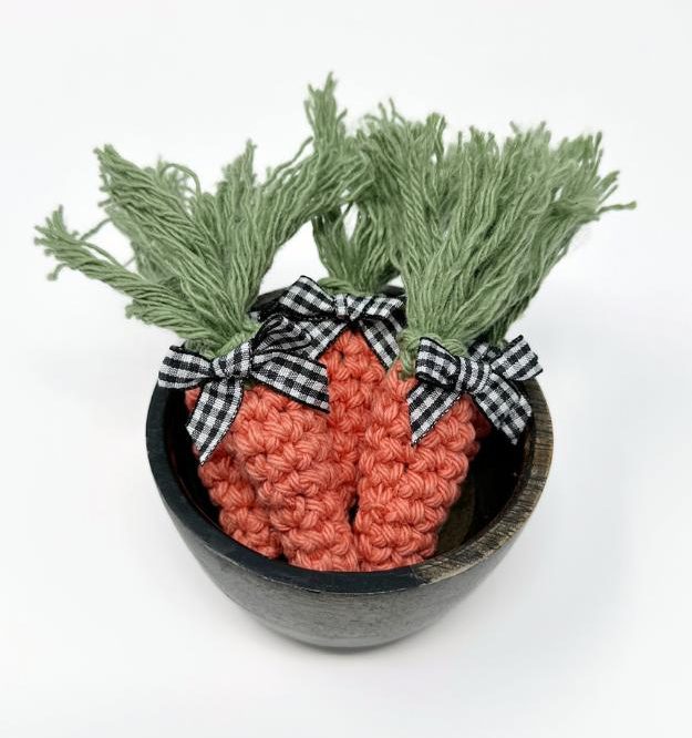 mini crochet carrots in a bowl