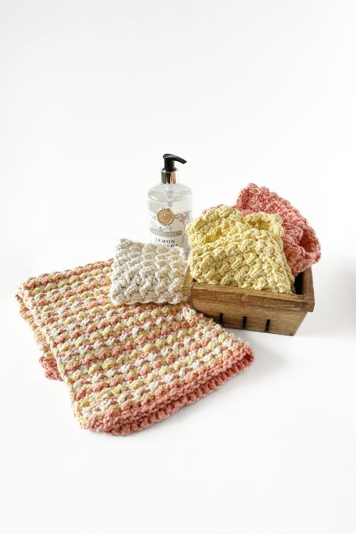 crochet dishcloth and towel set with soap pump on a white background