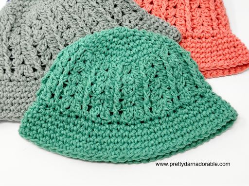 a group crocheted hats are laid out on top of each other