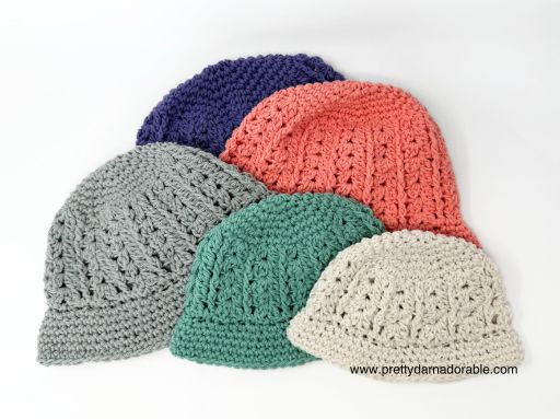 a group crocheted hats are laid out on top of each other