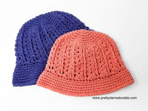 a group crocheted hats are laid out on top of each other