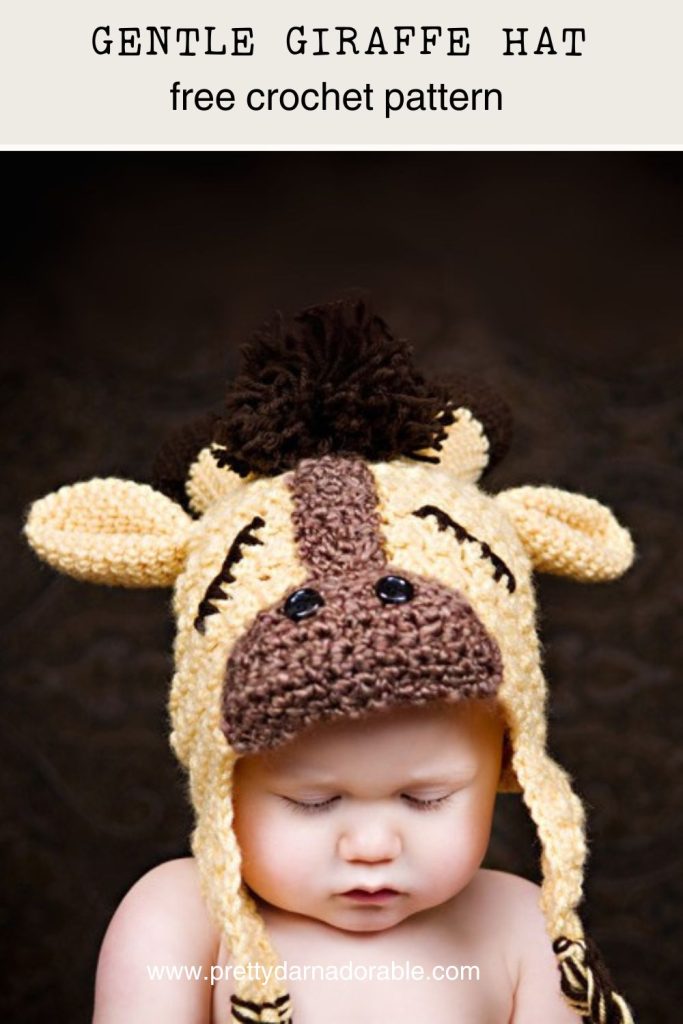 Baby wearing a yellow crochet giraffe hat with ears and mane, looking down; text reads “Gentle Giraffe Hat free crochet pattern.”. Free crochet pattern