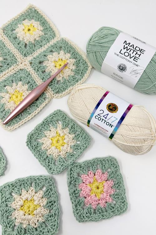 Pastel granny squares with floral centers, a pink crochet hook, mint and cream yarn on white; text reads, Celebrate Granny Square Day. Free crochet pattern
