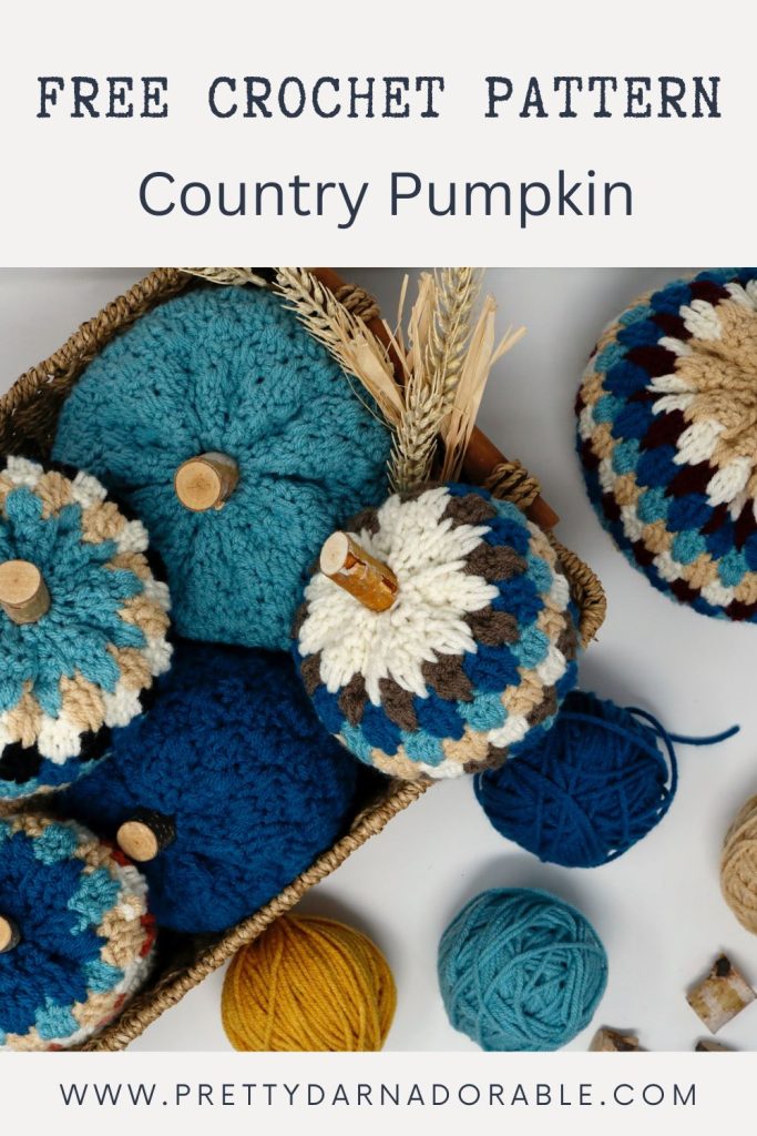 a basket filled with crocheted pumpkins and yarn