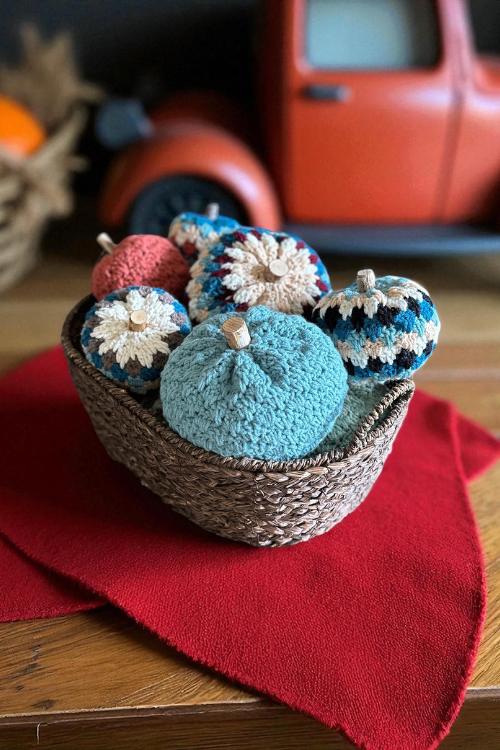 a basket filled with crocheted pumpkins and yarn. free crochet pumpkin pattern