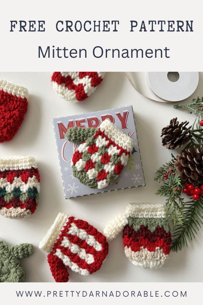 Red, green, and white crocheted mitten ornaments surround a “Merry Christmas” card, pine branches, ribbon; promo text above reads “Free Crochet Pattern Mitten Ornament.”. Free crochet pattern