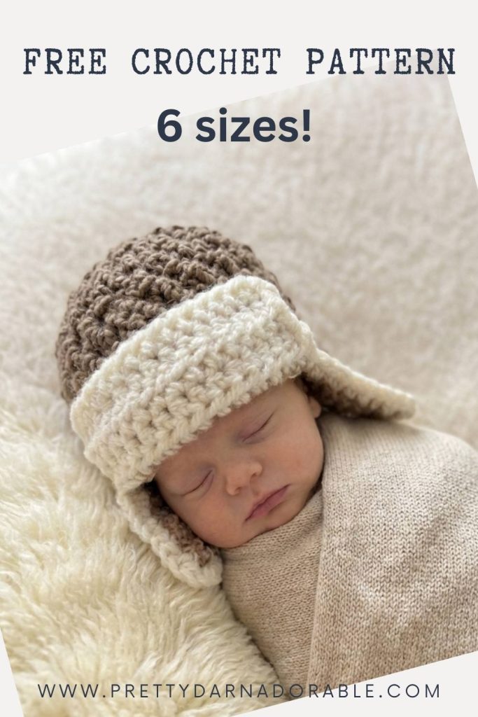Newborn baby sleeping in beige blanket, wearing brown and cream crocheted aviator hat; text: “Free Crochet Aviator Hat Pattern—6 sizes!” and website at bottom. Free crochet pattern