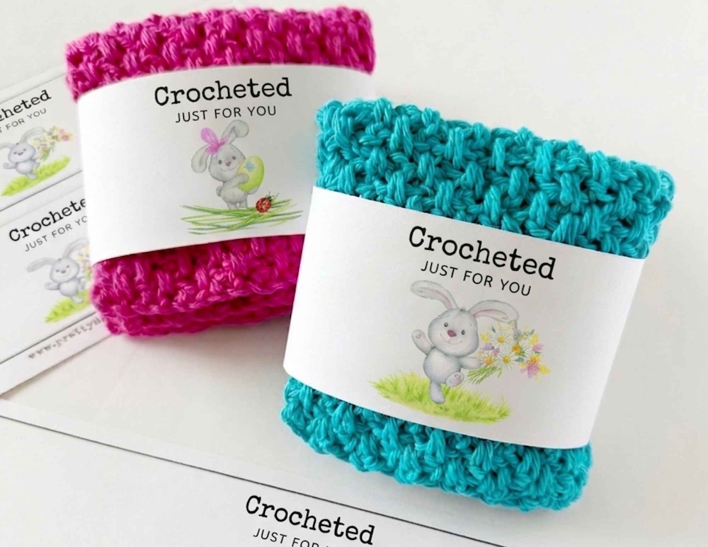 Pink and blue crocheted items wrapped in white labels that say "Crocheted Just for You" with bunny designs, promoting Easter tags. Free crochet pattern