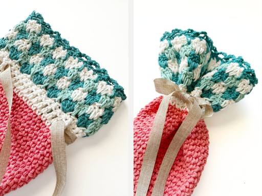 Handmade crochet pouch with a pink body and teal-white top, open on left and tied with beige ribbon on right; no text visible. Free crochet pattern