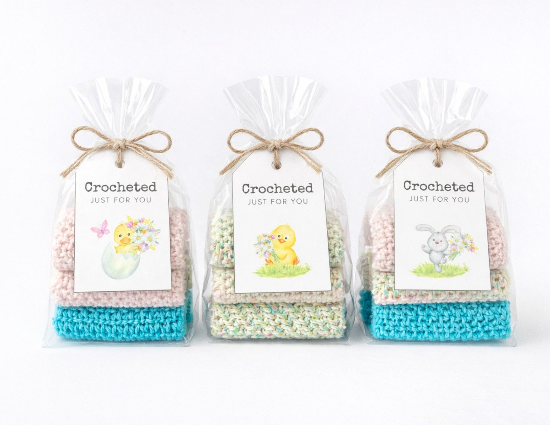 Three pastel crochet gift sets in clear wrap with twine bows, each labeled with an Easter chick, bunny, or bird illustration. Free crochet pattern