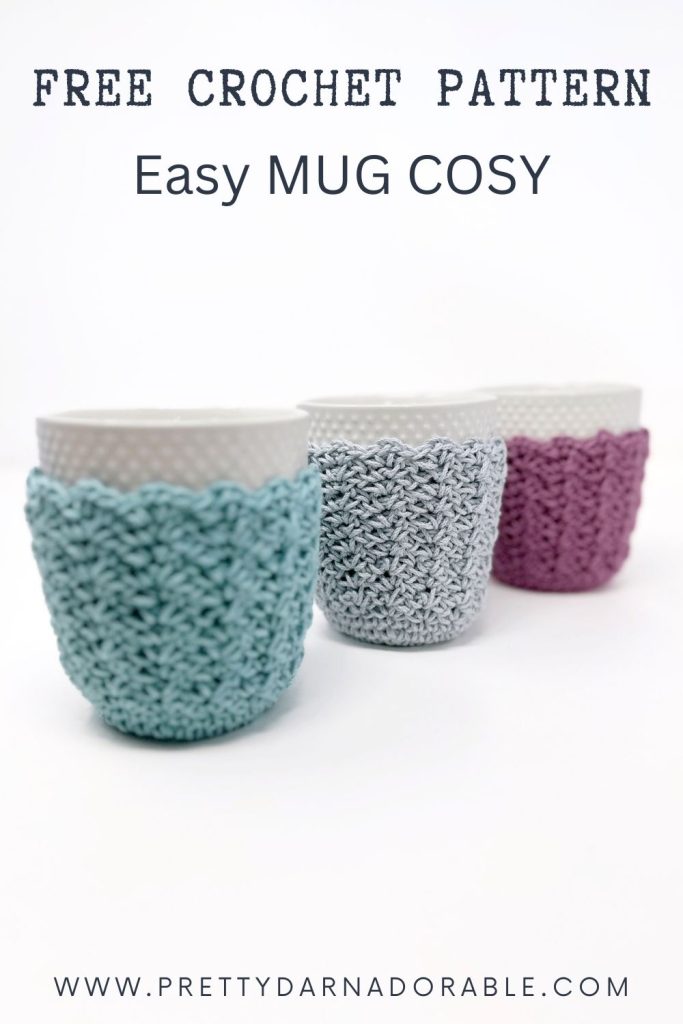 Three white mugs with pastel blue, gray, and pink crocheted cozies. Text: Free Crochet Mug Cozy Pattern: Easy Mug Cosy. www.prettydarnadorable.com. Free crochet pattern