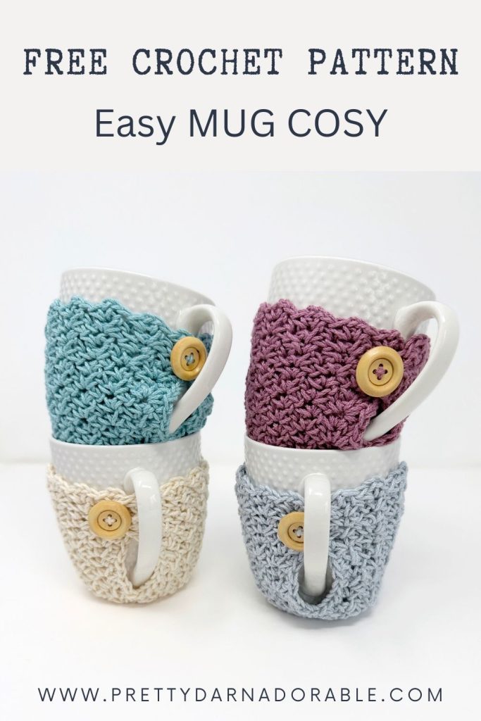 Four white mugs with bright crochet cozies and wooden buttons are stacked. Top text: Free Crochet Mug Cozy Pattern, Easy Mug Cosy. Bottom: prettydarnadorable.com. Free crochet pattern
