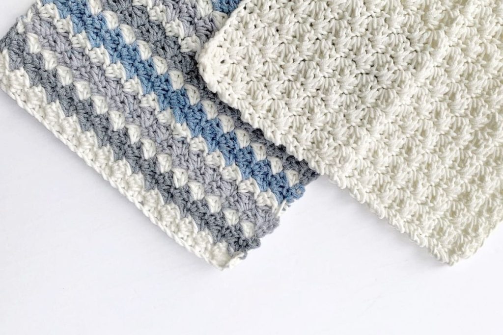Two crocheted rectangles with puff stitch texture are shown side by side on a white surface; one is solid white, and the other has stripes in white, gray, and blue. No visible text or promotional information appears in the image. Free crochet pattern