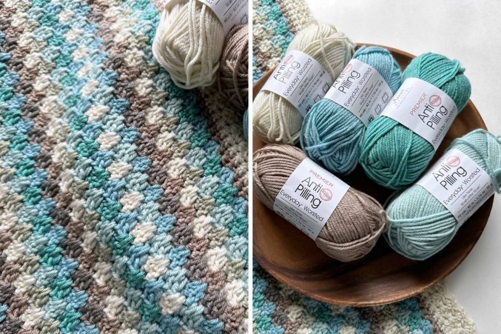 A close-up of a crocheted blanket in teal, blue, beige, and cream lies beside a wooden bowl holding six skeins of matching anti-pilling baby yarn on a white surface; no text or promotional materials are visible. Free crochet pattern